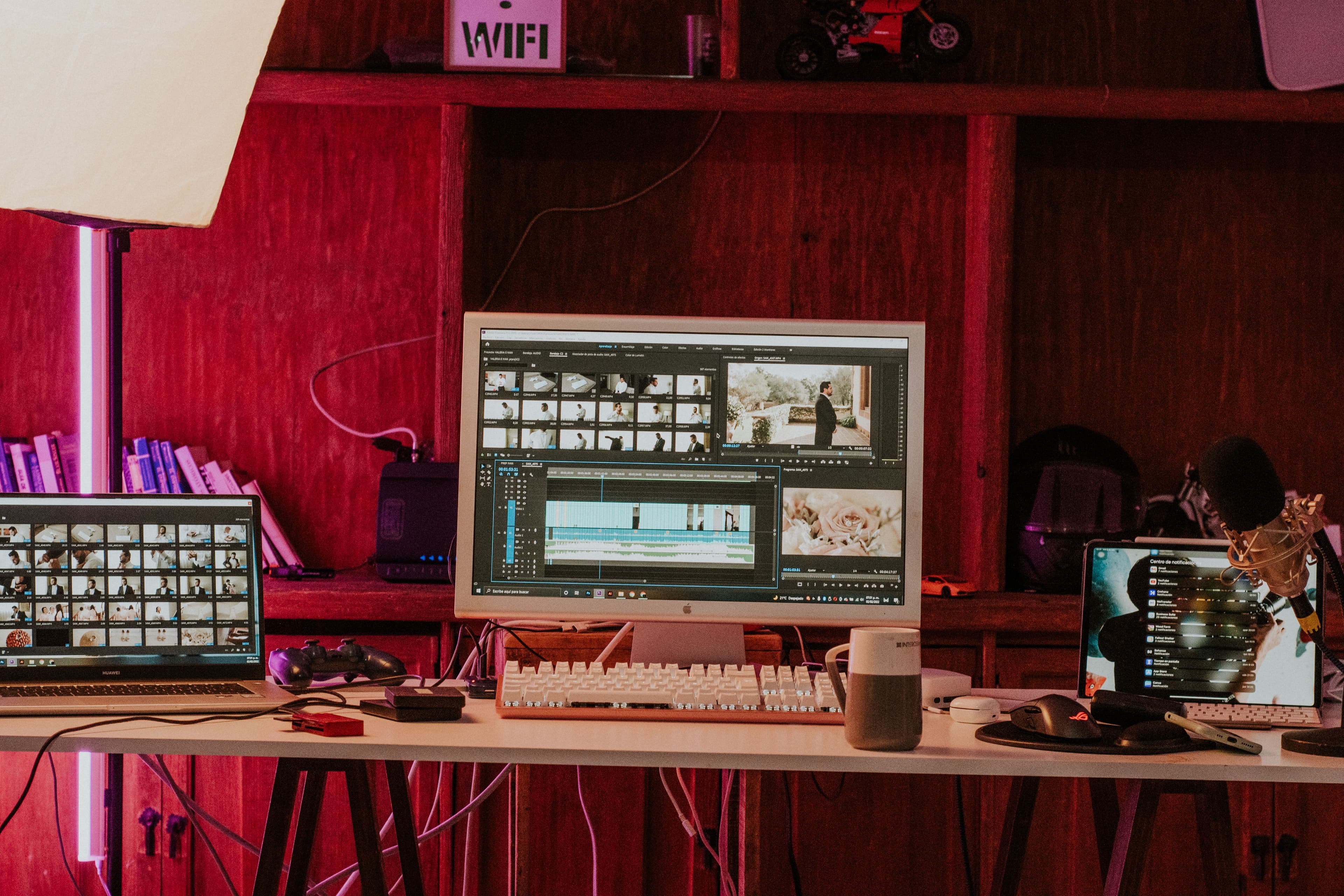 Estação de trabalho de edição de vídeo com monitores e laptop